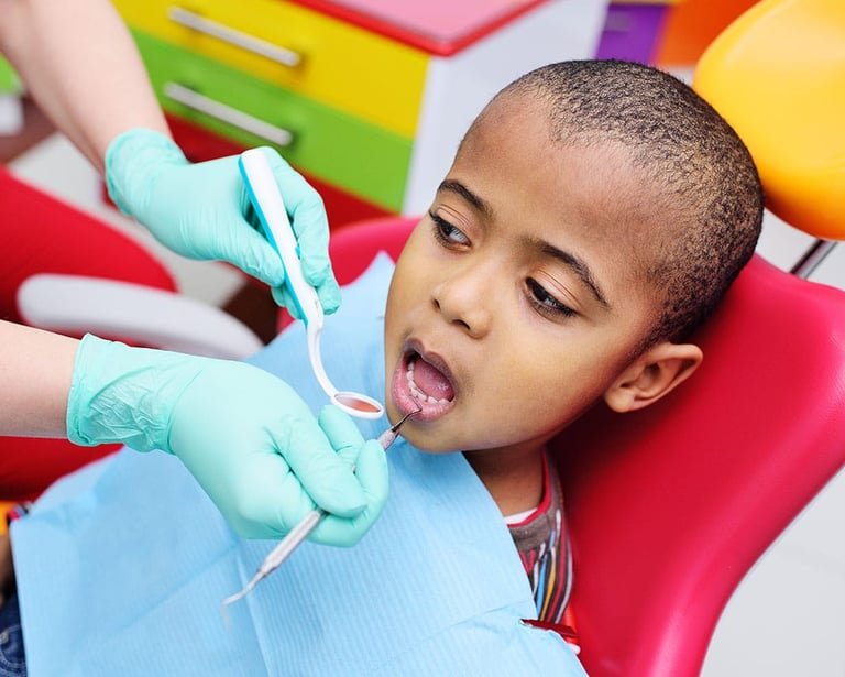 Young boy receiving emergency dental checkup from a dentist using a mouth mirror and probe.